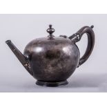 An early Georgian style bullet shape teapot, indistinctly marked, engraved crest,