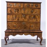 A George II style walnut chest on stand, cavetto moulded outline,