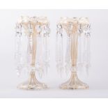 A pair of Victorian overlaid glass lustre vases, conical stems, bottom knopped,