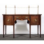 A George III mahogany bowfront sideboard, brass rail back, fitted with a central frieze drawer,