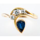 A sapphire and diamond dress ring, the pear shaped sapphire collet set,