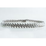 A diamond set bracelet, fifty nine 18 carat white gold leaf shape links each set with diamonds (6),