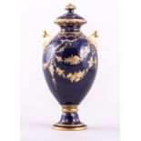 A Royal Crown Derby bone china royal blue ground urn shape covered vase, 1895, with scroll handles,