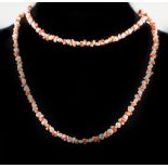 A freshwater pearl necklace alternating with pairs of coral chips, 78cm long.