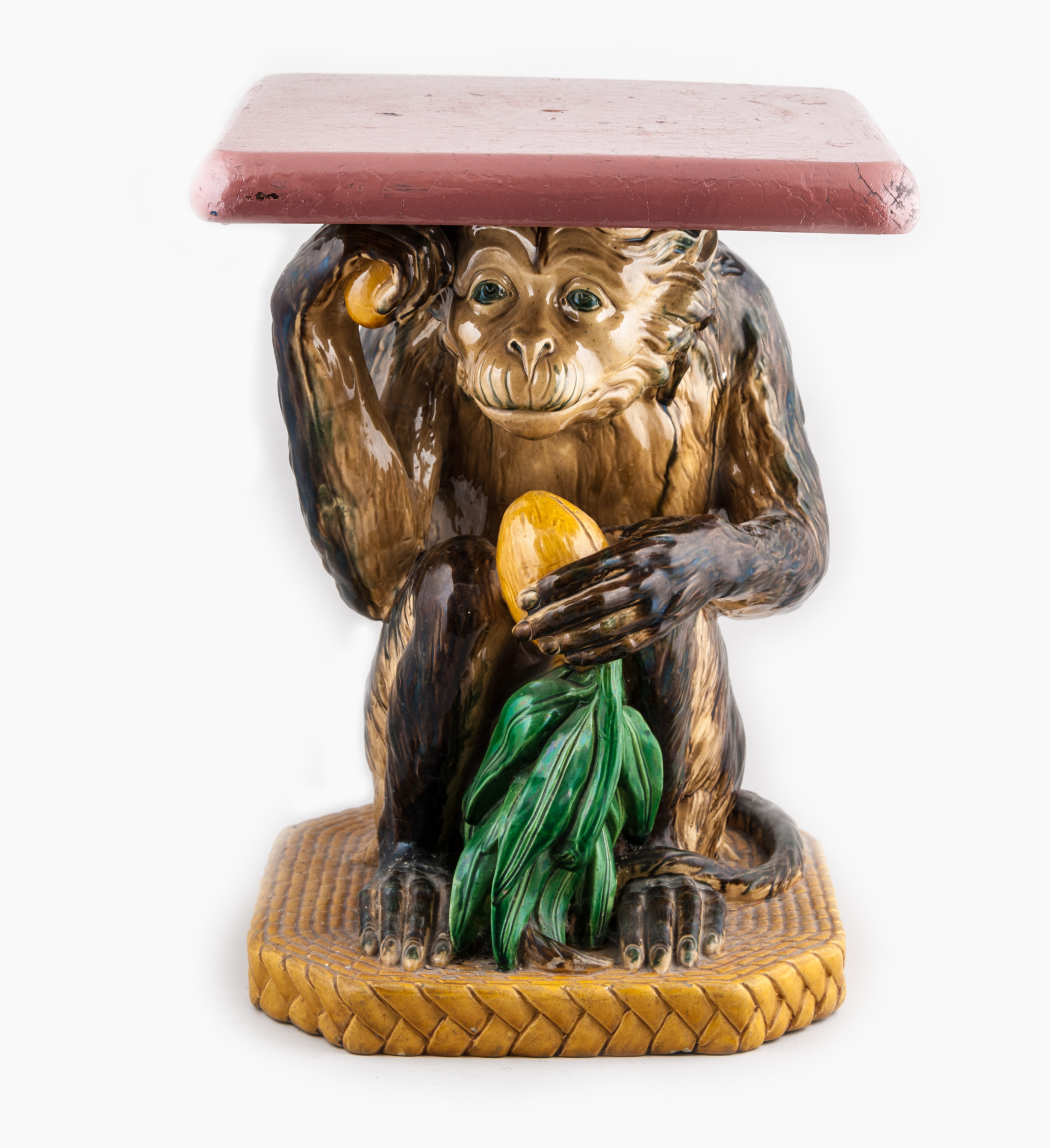 A Minton and Co Majolica Monkey seat, 1872, modelled as a crouching monkey holding a coconut,