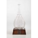 Novelty glass decanter, early 19th Century designed as a pair of bellows, 28cm on a walnut stand.