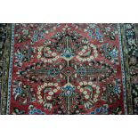 Hamadan pattern rug, stylised floral pattern within four borders, red ground, 246cm x 161cm.