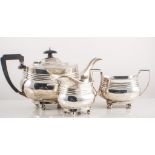 Silver three piece tea set, oval form with ribbed band on four ball feet, Birmingham 1919/1920,