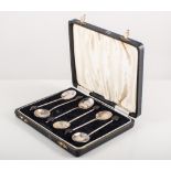 Cased pair of silver toast racks, Sheffield 1935, and a cased set of silver coffee bean spoons.