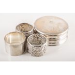 Pair of silver napkin rings, engraved with embossed and chased decoration, indistinct makers mark,