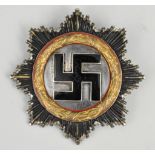 A Third Reich German Gold Cross, the reverse with four rivets and the pin stamped "20", 6.