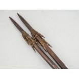 Two tribal fishing spears, multi barbed, woven grip, length 160cms, (2).