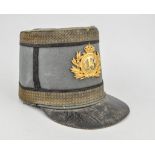 A WWI shako, gilt metal badge number 13, marked N. OLAST, height 17cms.