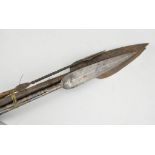 A tribal spear, leaf shaped blade, stained wood shaft, overall length 209cms,