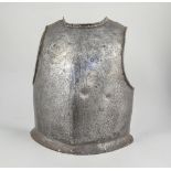 Armour; an Italian breastplate, traces of engraved decoration, probably 16th Century, height 44cms.