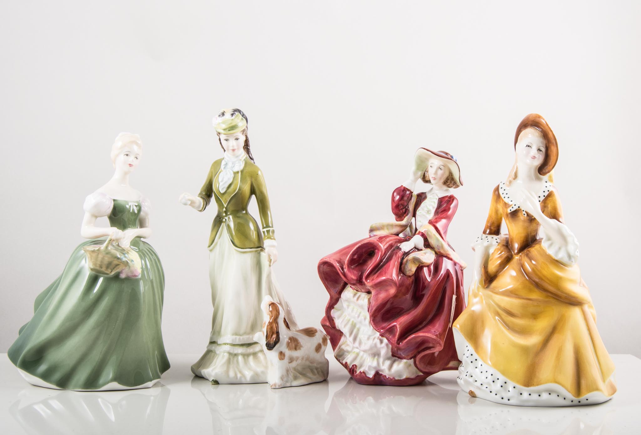 Five Royal Doulton figures, Top O' The Hill, HN 1834 (cracked), Sarah HN 3852, Clarissa HN 2345,