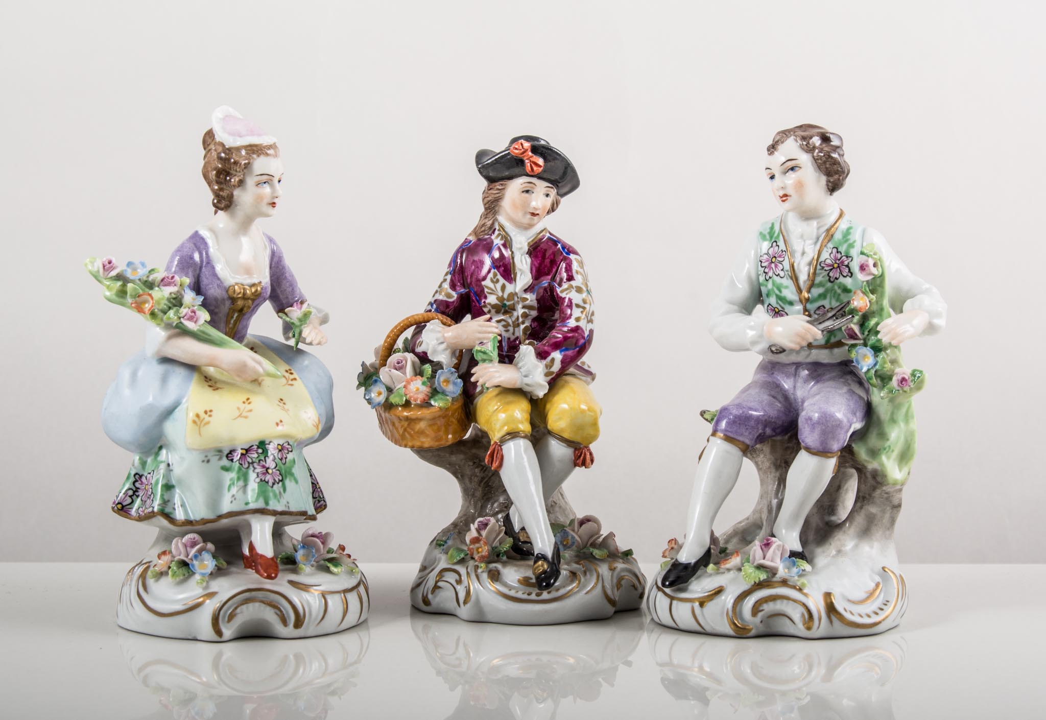 Pair of Sitzendorf models, lady and gentleman with flowers, painted in colours, gilt scroll bases,