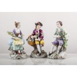 Pair of Sitzendorf models, lady and gentleman with flowers, painted in colours, gilt scroll bases,