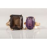 Two yellow metal dress rings, a rectangular smoky quartz claw set in 9 carat yellow gold,