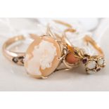 Four dress rings, a 9 carat gold tapered band set with five seed pearls, a cameo ring,