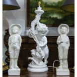 White painted figural lamp base modelled with a cherub and a pair of plaster figures of a Dutch boy