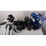 Minolta camera, two lenses and other camera equipment.