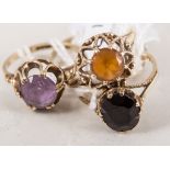 Four 9 carat gold dress rings, claw set with citrine, garnet, amethyst and a pale turquoise stone,