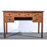 An English Arts and Crafts oak desk, with four frieze drawers above two further drawers,