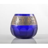 Moser, a glass vase, blue faceted body with figural gilt overlaid band,