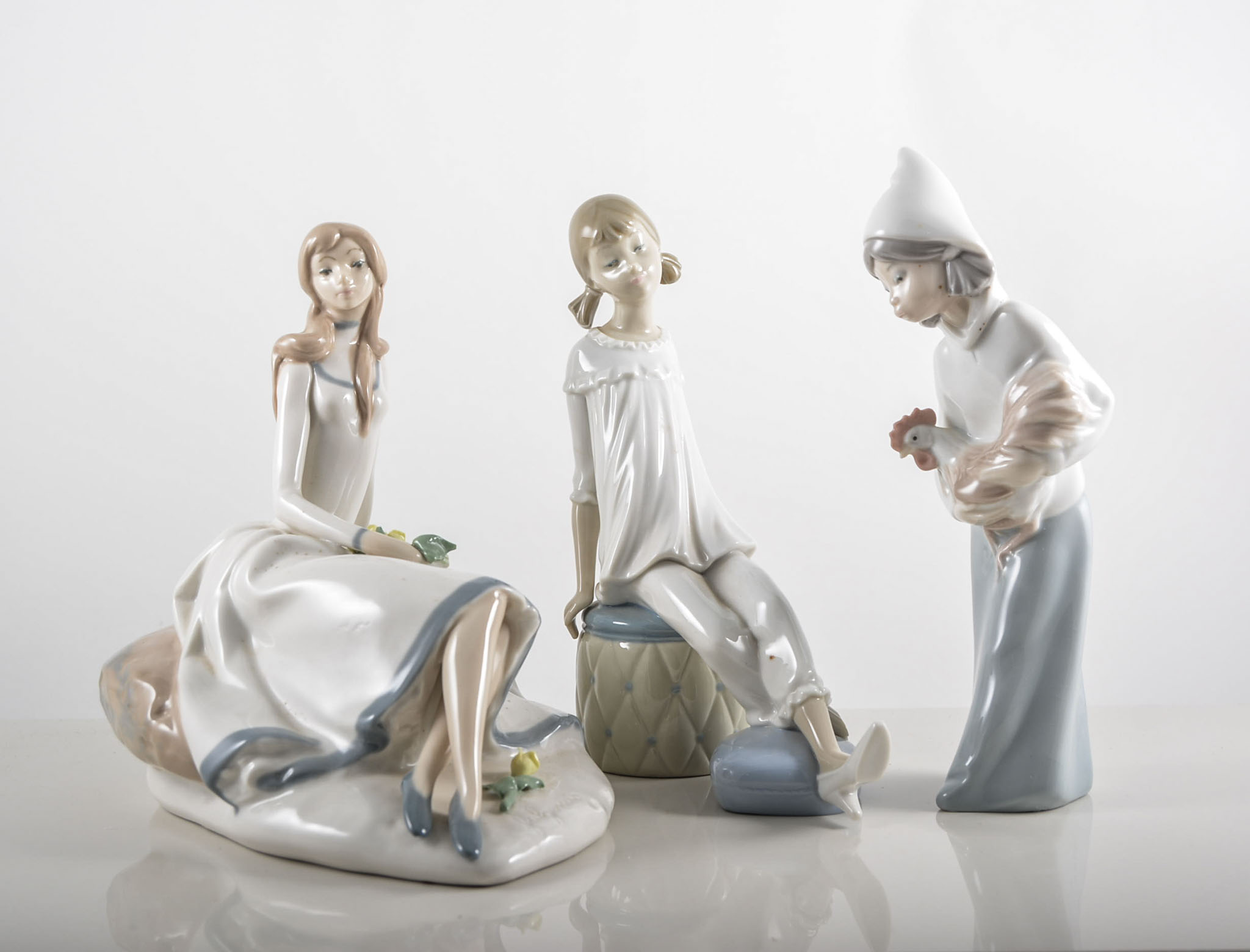 Lladro porcelain model of a girl with a chicken, height 20cms and other Lladro models,