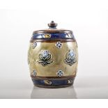 Doulton stoneware tobacco jar and cover, barrel form, with applied flower motifs, impressed marks,