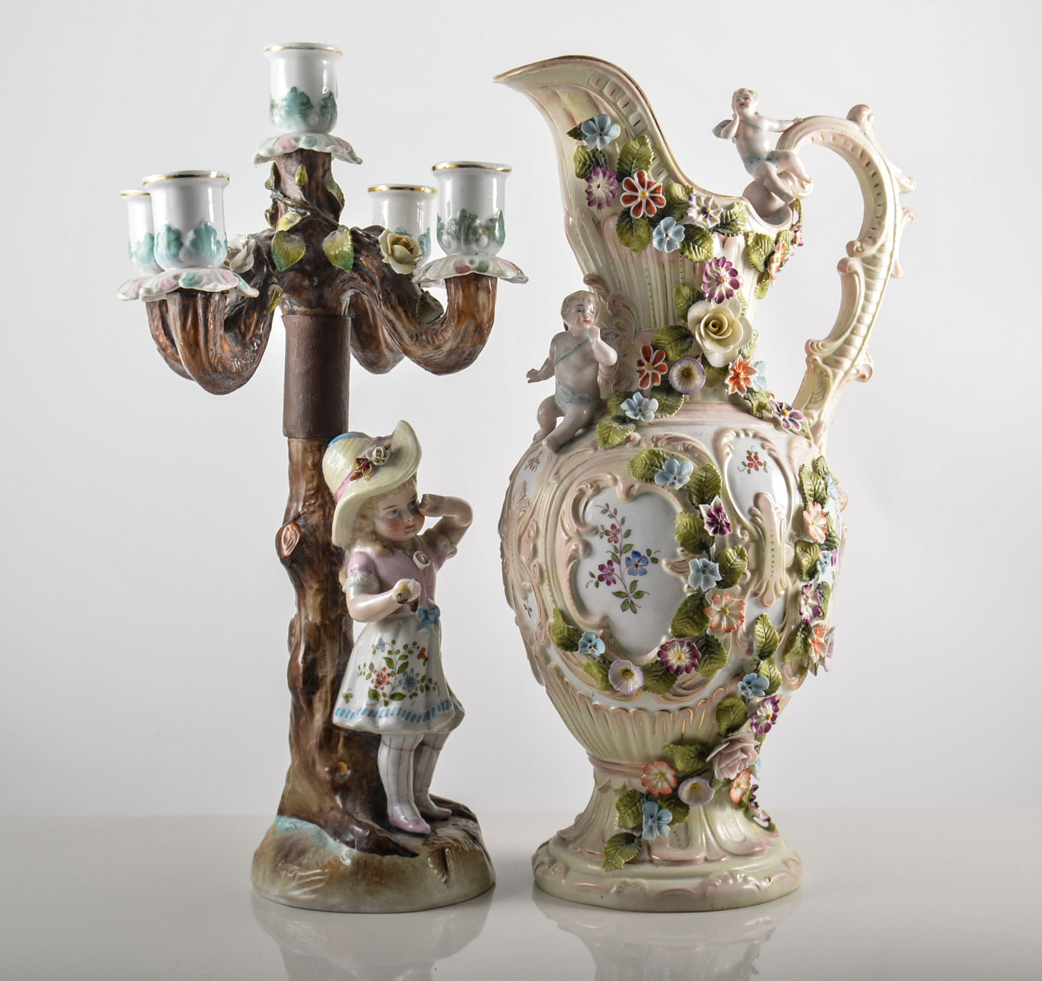 Continental porcelain five-light candelabra, rose encrusted, modelled with a girl, (restored),