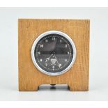 Smiths car clock, 8.5cm diameter, mounted in an oak frame.