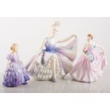 Four Doulton figures and one Worcester figure,