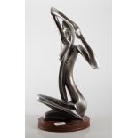 A modern gunmetal grey sculpture in the Austin style of a female form, seated,