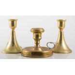 Pair of brass candlesticks and a chamberstick, (3).