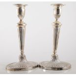 Pair of silver candlesticks, fluted bases.