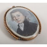 Small oval miniature portrait, yellow metal frame, memorial monogram to reverse.