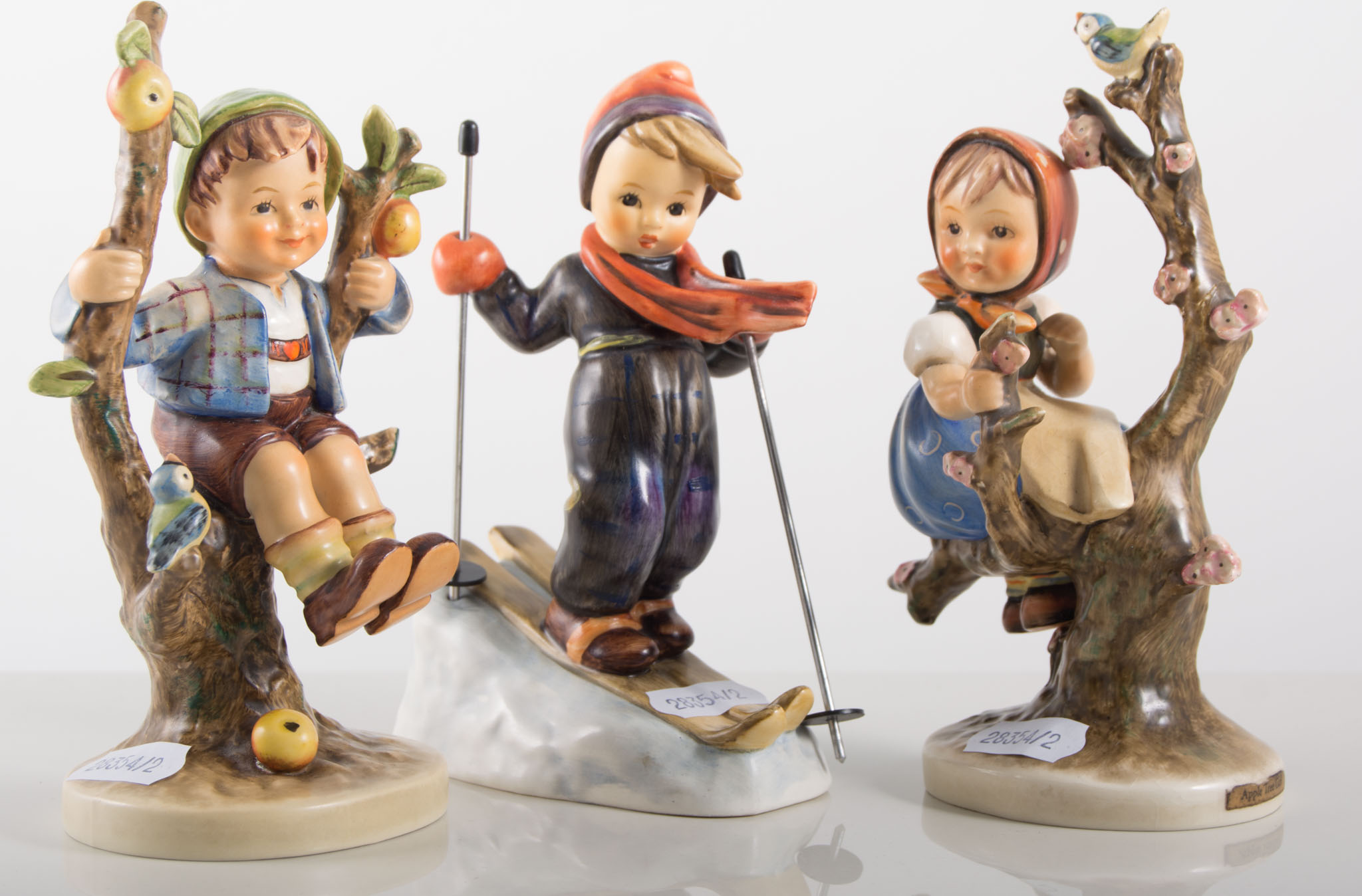Group of four Hummel figures, including, Boy with Two Piglets,