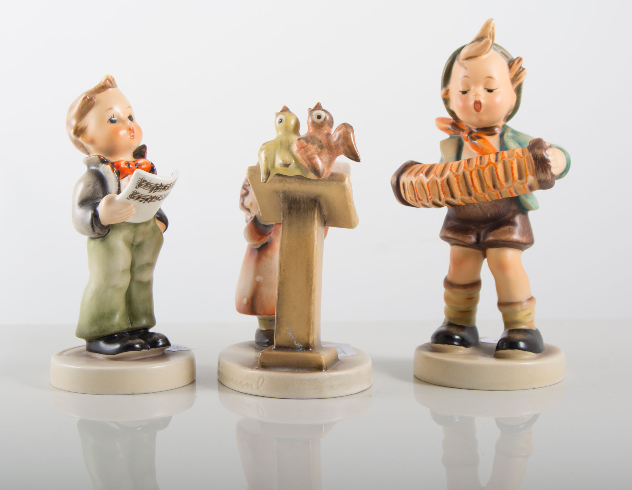 Three Hummel figures of a musical nature.