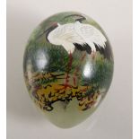 Decorated hardstone egg, painted with cranes, 37cms.