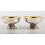 Pair of silver gilt lined dishes, 12cms in diameter on circular pedestal foot with egg,