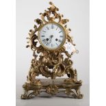 Brass cased French style clock, with ornate Rococo case with scrolls and floral swags,