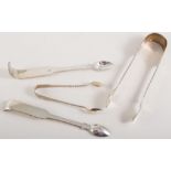 Assorted silver tongs and spoons.