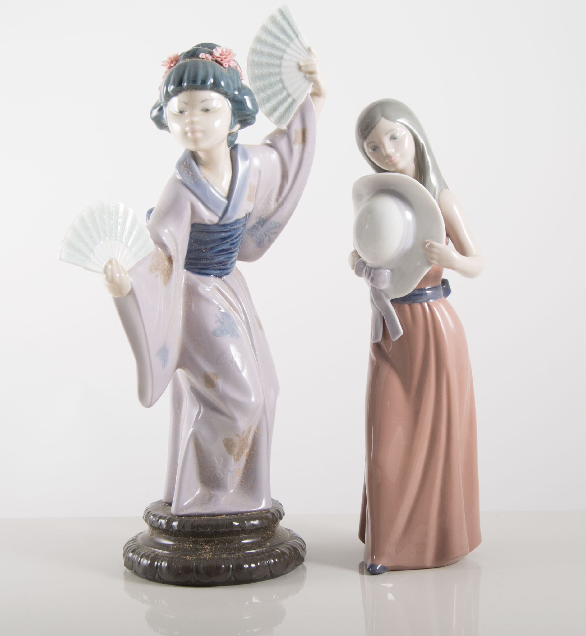 Lladro figurine, girl with bonnet No 5.007, and a Geisha girl with two fans, (2).