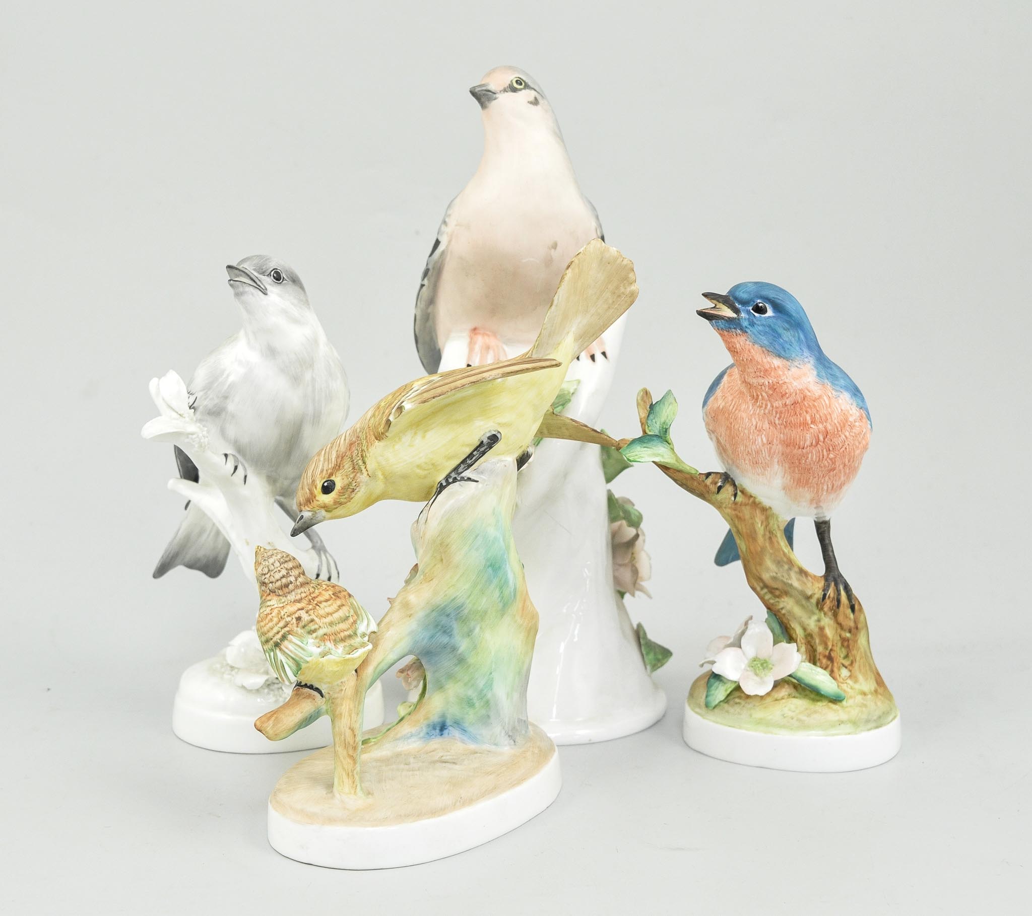 Six Crown Staffordshire bird groups, four by Doris Lindner, including 'Blue Bird',