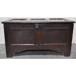 A joined oak coffer, hinged top, knulled frieze, two panel front, 18th Century and later.