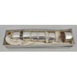 Set of six silver napkin rings, plain cylindrical form with beaded outlines, numbered 1-6, JR,