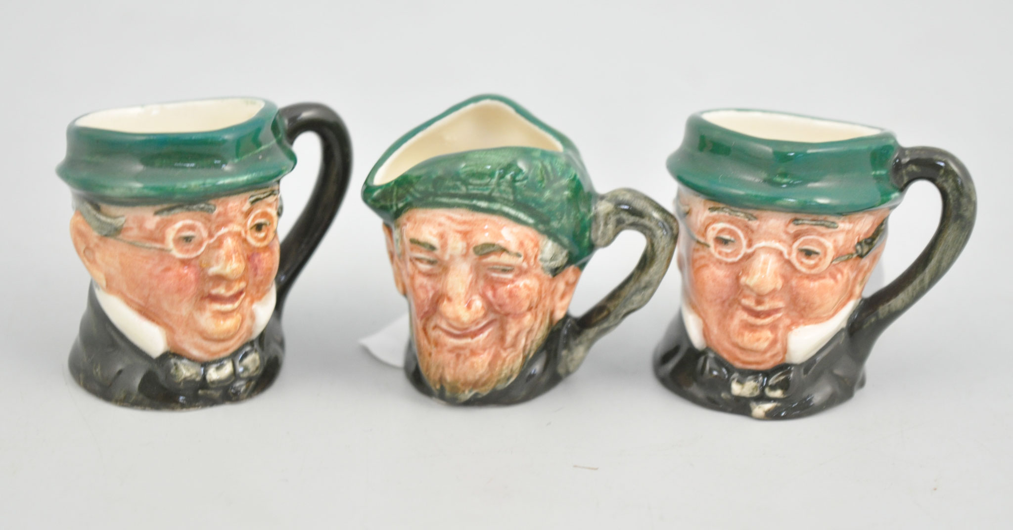 Three miniature Royal Doulton pottery character jugs, height 3.5cms.