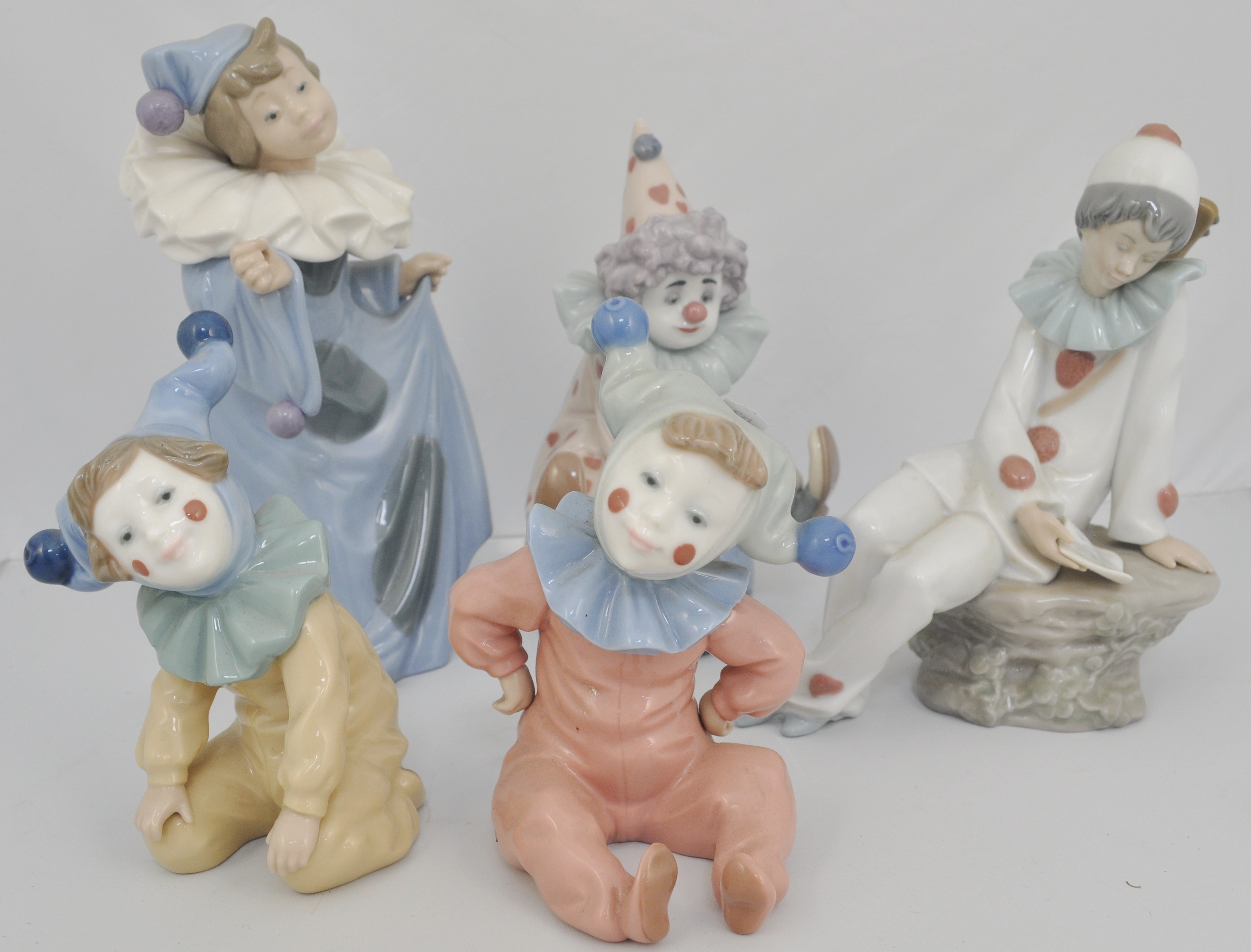 Lladro figure, of a boy clown, 18cms, and four Nao models of clowns, (5).